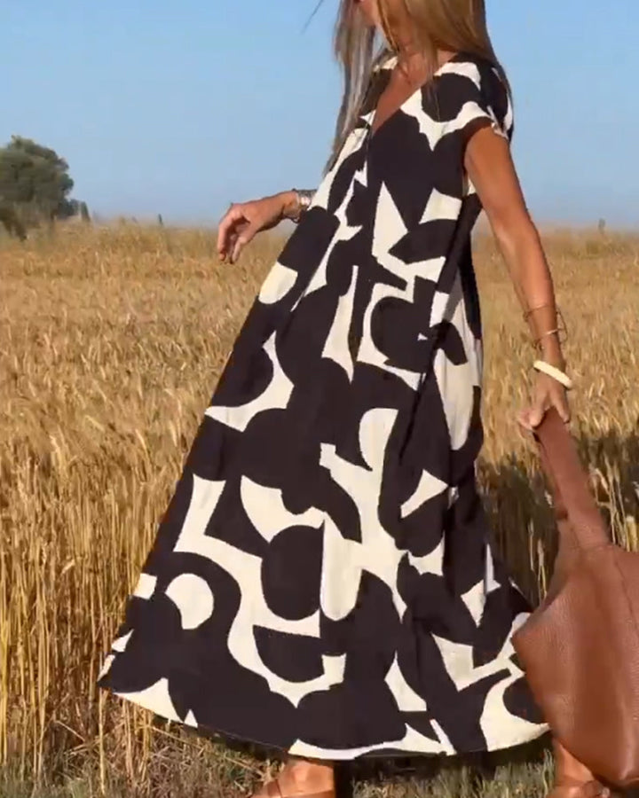 NAOMI | Lange Geprinte Jurk met V-hals en Uitlopende Pasvorm voor een Vakantielook